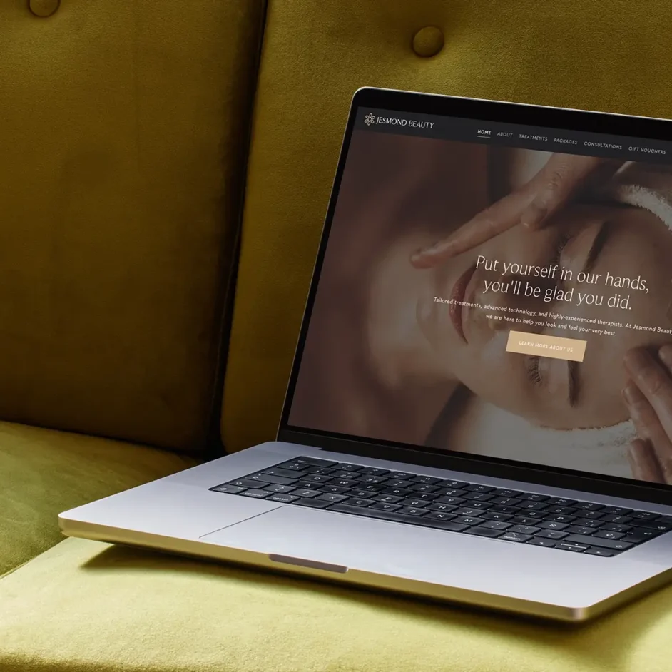 open laptop on a green velvet sofa