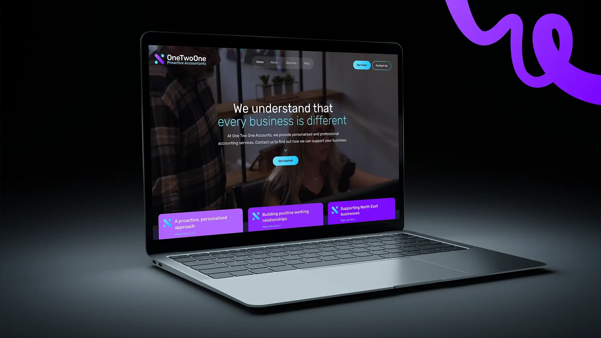 laptop on a dark background displaying a website