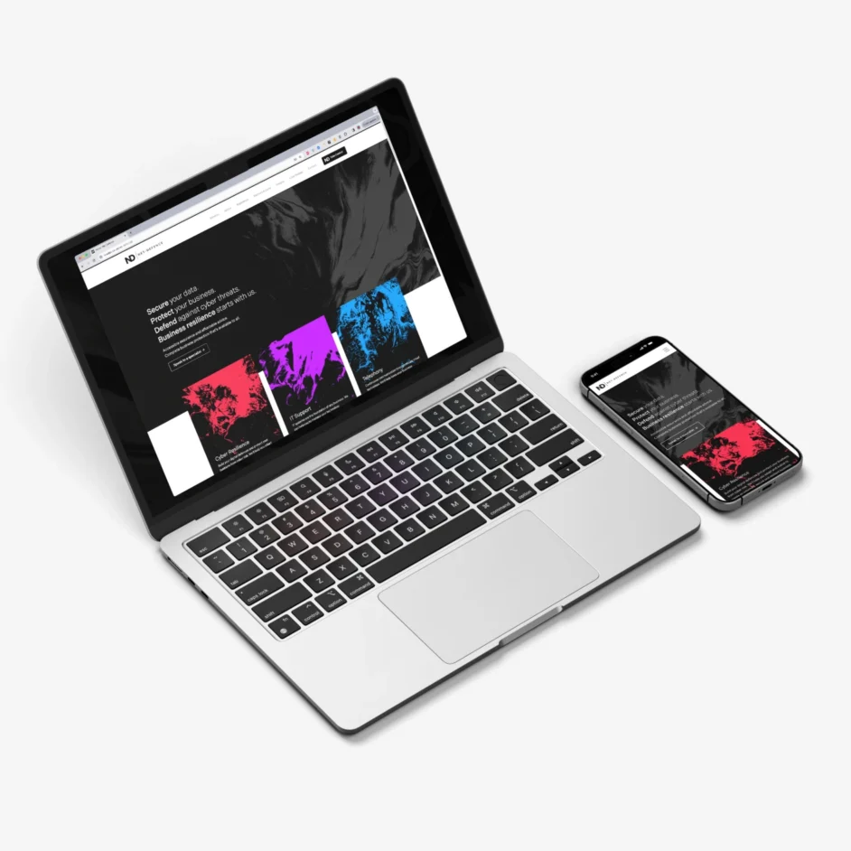 A MacBook and iPhone displaying the Net-Defence website.