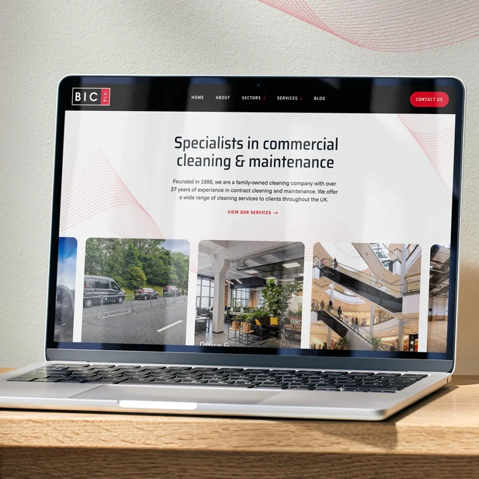 A Macbook on a table displaying BIC website.