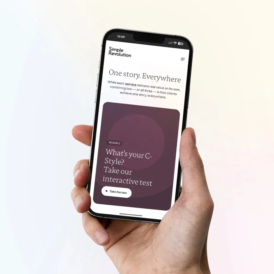 A smartphone with the Simple Revolution website on the screen.