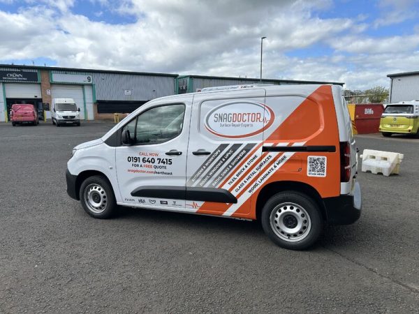 A Snag Doctor branded van in the company’s orange colour scheme. 