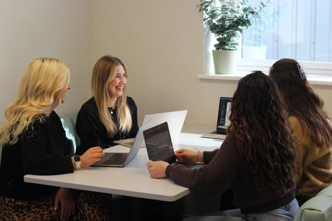 A group of colleagues sat around a table during a meeting. 